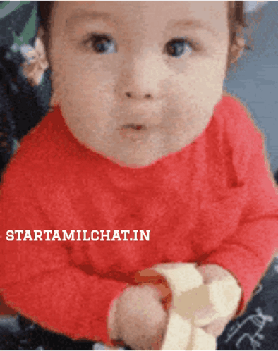 Baby In Red Shirt Holding Banana With Starttamilchat.in GIF