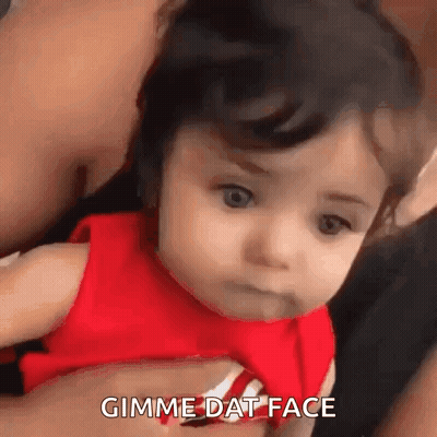 Baby In Red Shirt Making Funny Face GIF