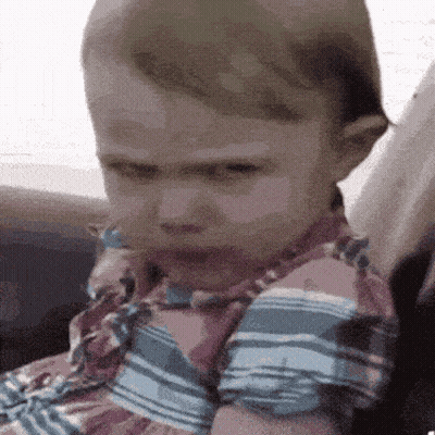 Baby In Striped Shirt Making Face GIF