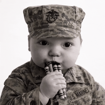 Baby In U.S. Marines Uniform Chewing Crayons GIF
