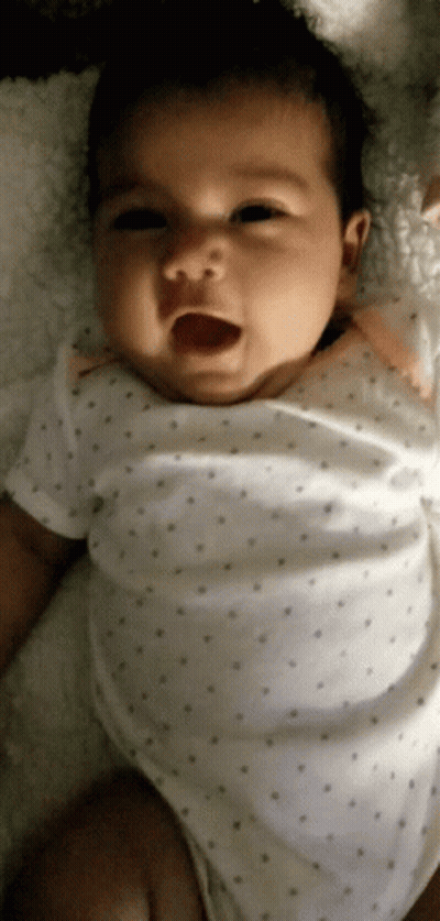 Baby In White Polka Dot Shirt Laying On Blanket GIF