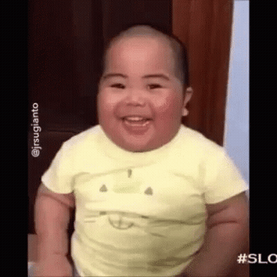 Baby in Yellow Shirt Smiling and Laughing