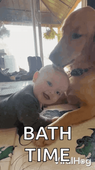 Baby Laying Next To Dog Saying Bath Time GIF