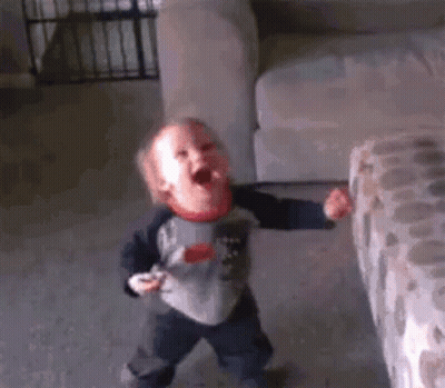 Baby Laying On Bed Making Funny Face GIF
