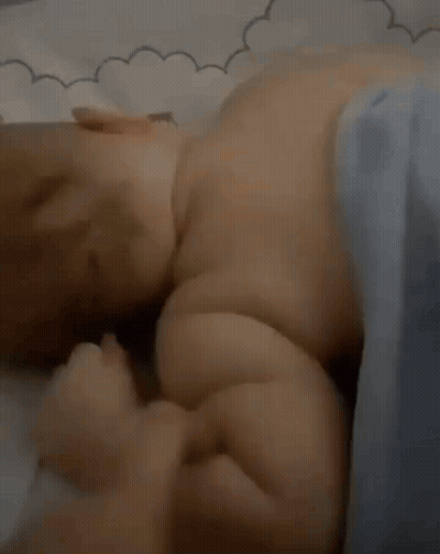 Baby Laying On Bed With Blue Blanket GIF