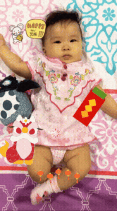 Baby Laying On Bed With Happy Sign GIF
