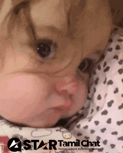 Baby Laying On Bed With Star Tamil Chat Logo GIF