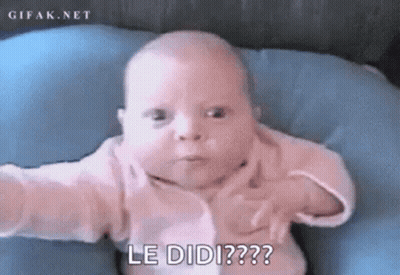 Baby Laying On Blue Pillow Making Funny Face GIF