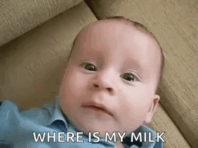 Baby Laying On Couch Making Funny Face GIF