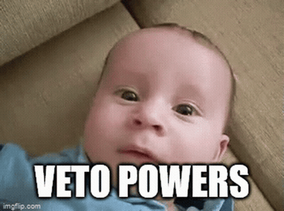 Baby Laying On Couch Making Funny Face Veto Powers GIF