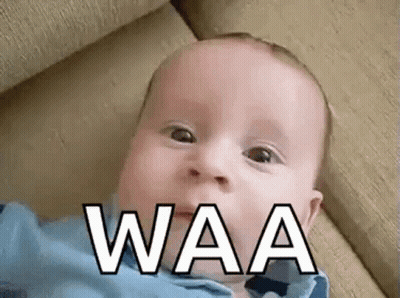Baby Laying On Couch Making Funny Face Waa GIF