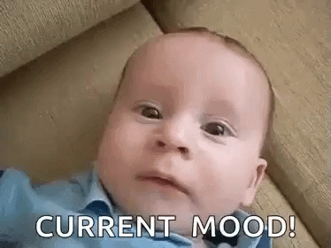 Baby Laying On Couch With Current Mood On Face GIF