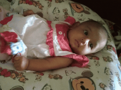 Baby Laying On Mickey Mouse Pillow GIF