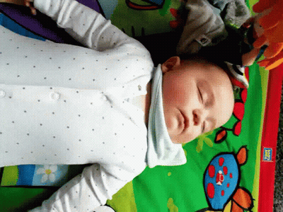 Baby Laying On Play Mat With Fisher Price Sticker GIF