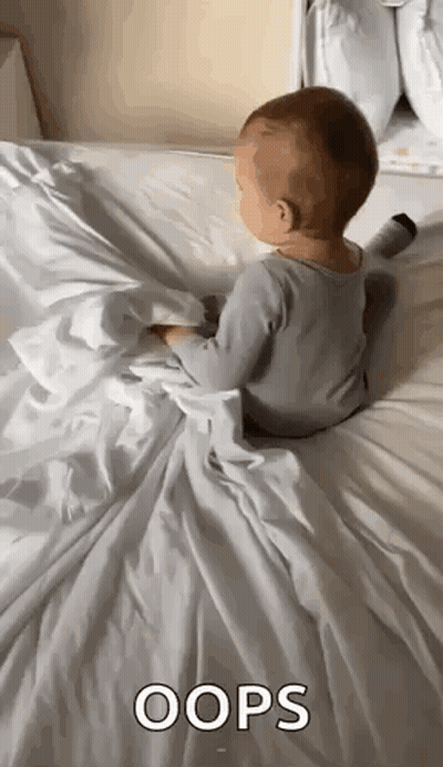 Baby Laying On White Blanket And Pillow GIF