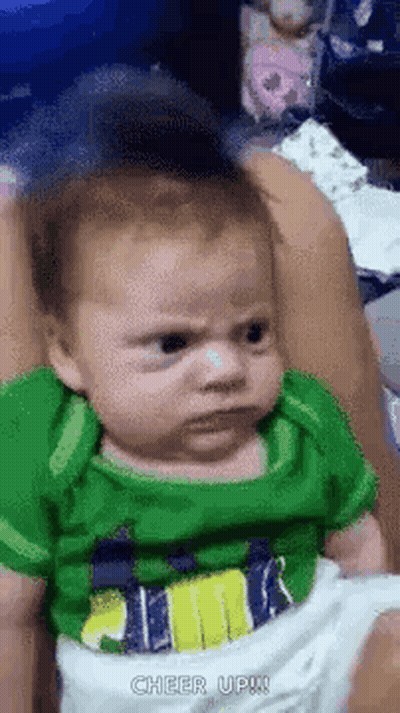 Baby Making Funny Face Held By Woman GIF