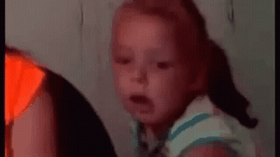 Baby Making Funny Face On Couch GIF
