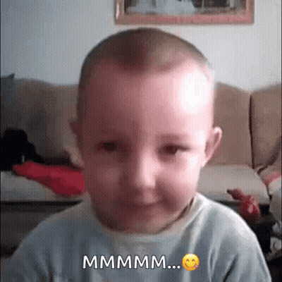 Baby Making Funny Face Saying Mmmm GIF