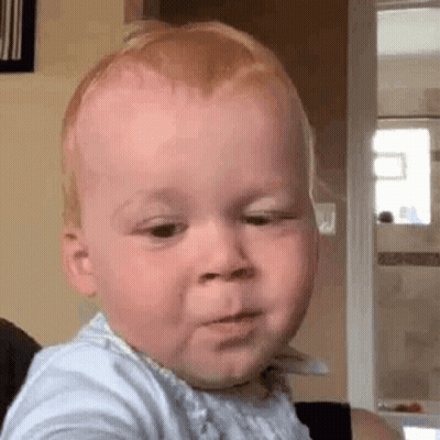 Baby Making Funny Face Sitting On Chair GIF