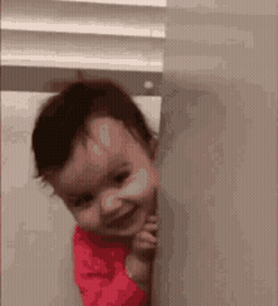 Baby Peeking From Behind Wall Smiling