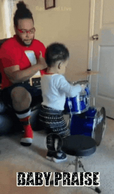 Baby Playing Drums With Man Behind GIF