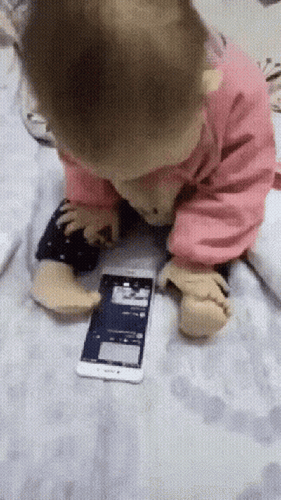 Baby Playing With Cell Phone On Blanket GIF