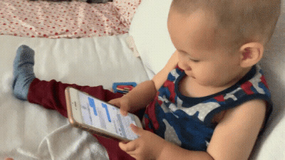 Baby Playing With Cellphone On Bed GIF