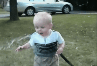 Baby Playing With Hose In Park GIF