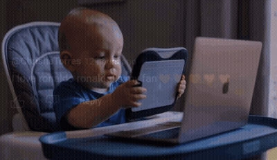 Baby Playing With Tablet And Laptop In High Chair GIF