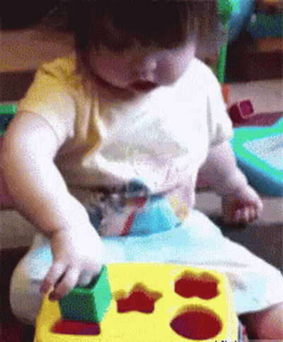 Baby Playing With Yellow Star Toy GIF