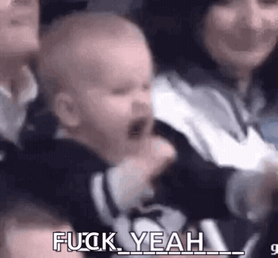 Baby Screaming In Crowd Held By Woman GIF