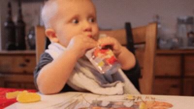 Baby Sitting At Table Eating From Bag GIF