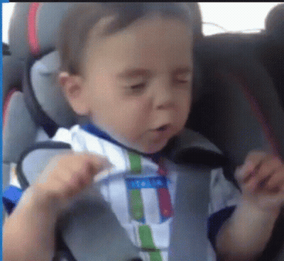 Baby Sitting In Car Seat With Eyes Closed And Striped Shirt GIF