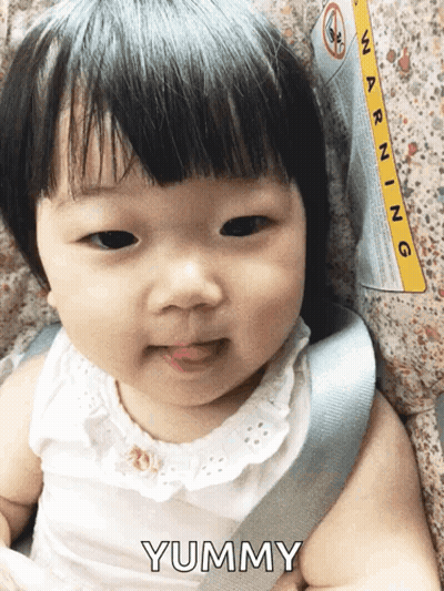 Baby Sitting In Car Seat With Warning Label GIF