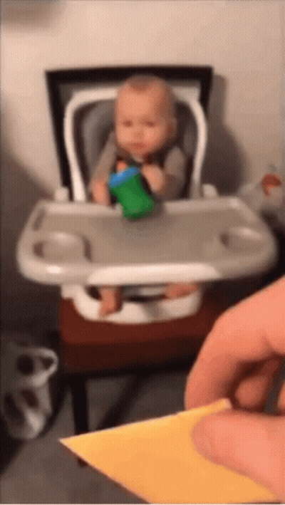 Baby Sitting In High Chair With Green Cup GIF