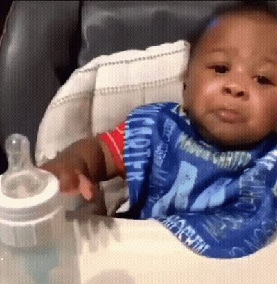 Baby Sitting In High Chair With Milk Bottle GIF