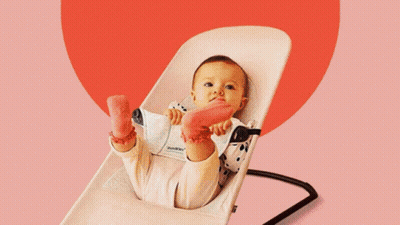 Baby Sitting in Rocking Chair With Toys