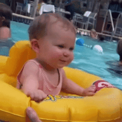 Baby Sitting In Yellow Raft In Swimming Pool GIF