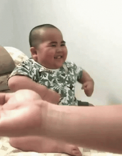 Baby Sitting On Bed With Person Holding Hand GIF
