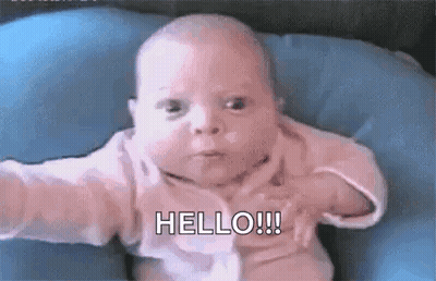 Baby Sitting On Blue Pillow Making Funny Face GIF