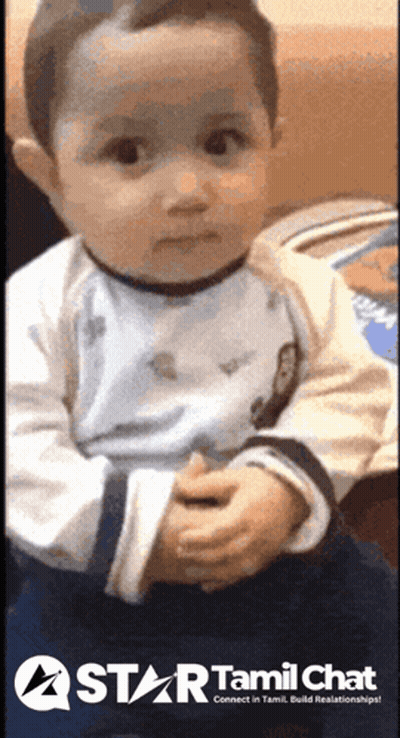 Baby Sitting On Couch In Front Of Star Tamil Chat Sign GIF