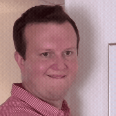 Baby Sitting On Couch Looking At Camera GIF