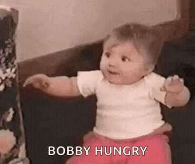 Baby Sitting On Couch Looking At Camera GIF