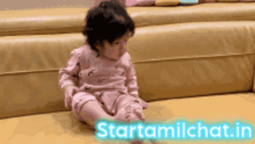 Baby Sitting On Couch Next To Starttamilchat Sign GIF