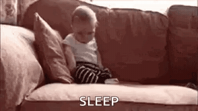 Baby Sitting On Couch With Pillows And Blanket GIF