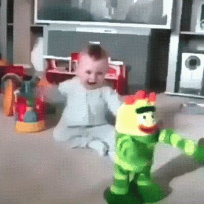 Baby Sitting On Floor Playing With Stuffed Toy GIF