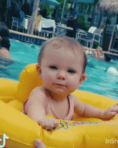 Baby Sitting On Yellow Raft In Pool GIF