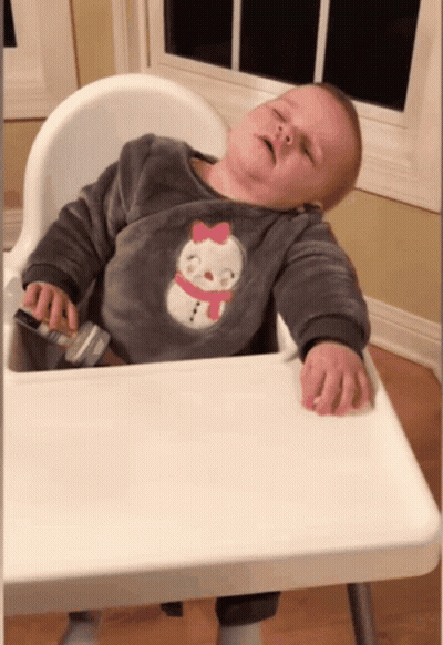 Baby Sleeping In High Chair With Snowman Sweater GIF