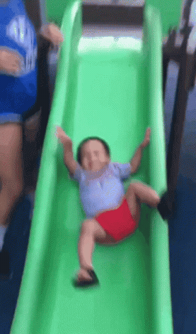 Baby Sliding Down Green Slide GIF