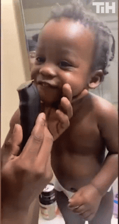 Baby Smiling While Held In Front Of Mirror GIF
